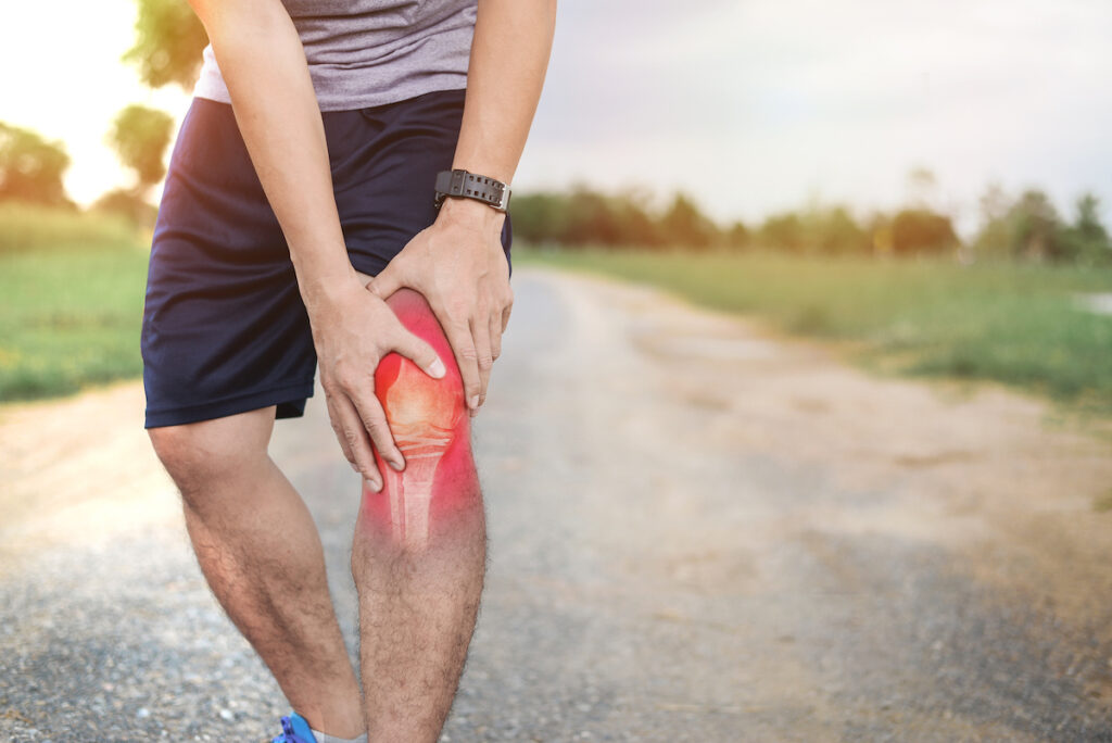 athlete man suffer from knee sprain while walking
